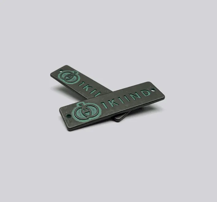 Sew-on metal decal with distressed finish