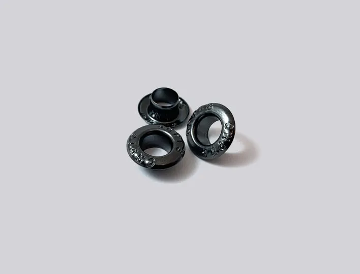 Engraved metal clothing eyelet.