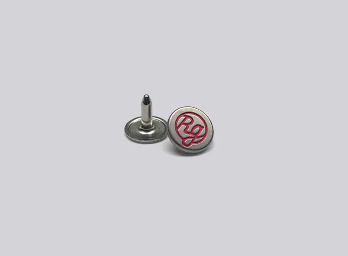 Brass capped rivet engraved with colour infill.