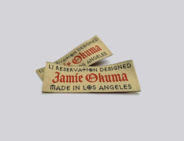 End folded woven brand label for clothing.